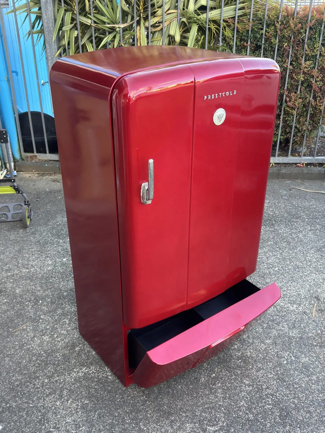 Restored retro Prestcold refrigerator in gloss red